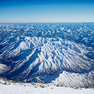 A-snowy-mountain-range-with-a-clear-blue-sky.